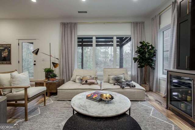 1168 Mado Loop, Chattahoochee Hills, GA 30268 - living room featuring beverage cooler, light wood-type flooring, recessed lighting, and healthy amount of natural light