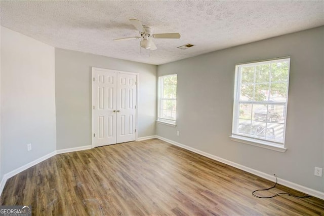 5920 Hampton Ct, College Park, GA 30349 - unfurnished bedroom with wood finished floors, a textured ceiling, baseboards, and a closet