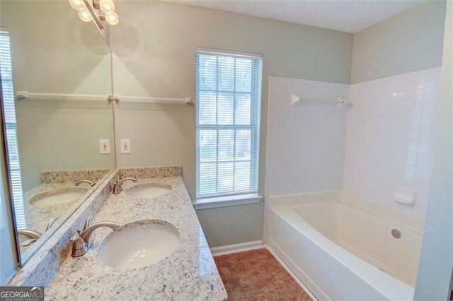5920 Hampton Ct, College Park, GA 30349 - full bathroom featuring healthy amount of natural light, double vanity, baseboards, and bathing tub / shower combination