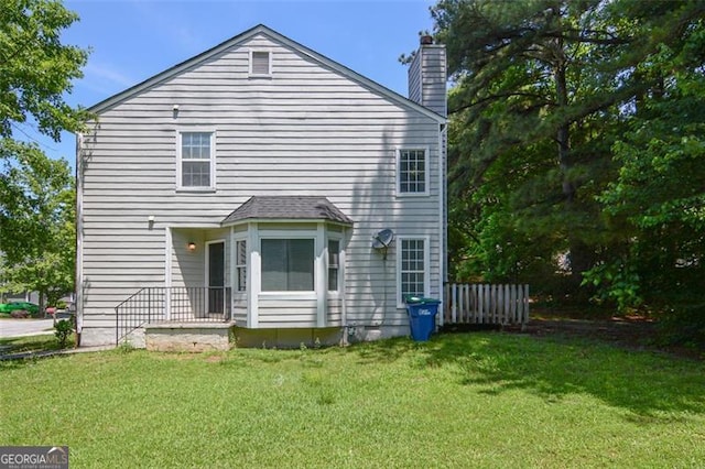 5920 Hampton Ct, College Park, GA 30349 - rear view of property with a chimney and a lawn