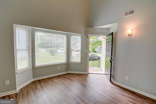 5920 Hampton Ct, College Park, GA 30349 - empty room featuring wood finished floors, healthy amount of natural light, baseboards, and a high ceiling
