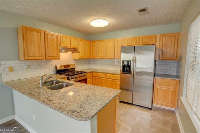 5920 Hampton Ct, College Park, GA 30349 - kitchen featuring stainless steel appliances, a sink, under cabinet range hood, a peninsula, and light stone countertops