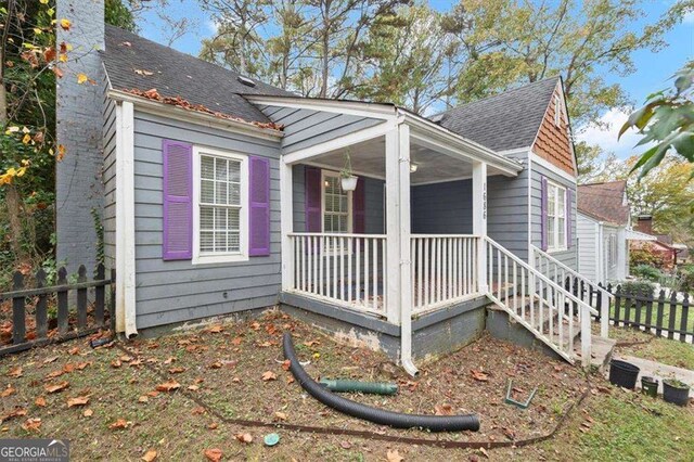 1686 Alvarado Ter SW, Atlanta, GA 30310 - view of property exterior with covered porch, roof with shingles, and a chimney