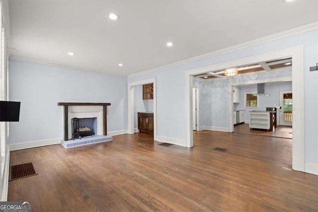 1686 Alvarado Ter SW, Atlanta, GA 30310 - unfurnished living room featuring ornamental molding, wood finished floors, a brick fireplace, and recessed lighting