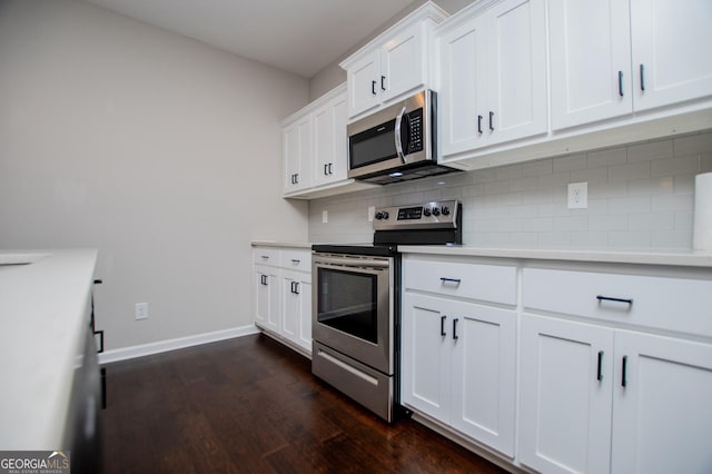 309 Dean Ct, Temple, GA 30179 - kitchen with appliances with stainless steel finishes, dark wood-type flooring, backsplash, light countertops, and white cabinetry