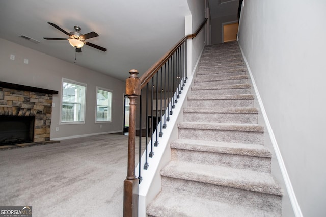 309 Dean Ct, Temple, GA 30179 - stairs with carpet floors, a ceiling fan, baseboards, and a stone fireplace