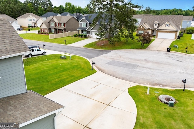 309 Dean Ct, Temple, GA 30179 - view of green lawn with a residential view, concrete driveway, and a garage