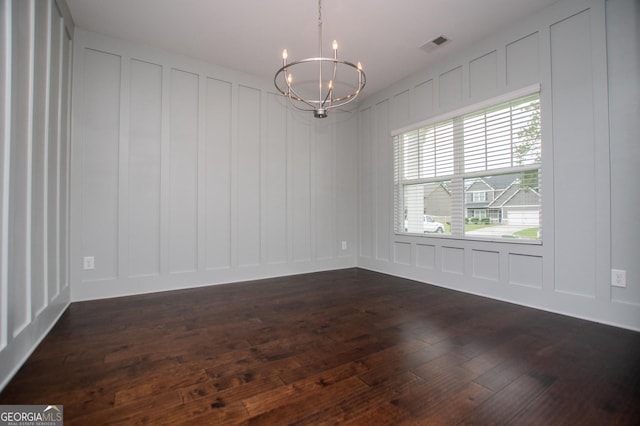 309 Dean Ct, Temple, GA 30179 - empty room with a decorative wall, a chandelier, and dark wood-style floors