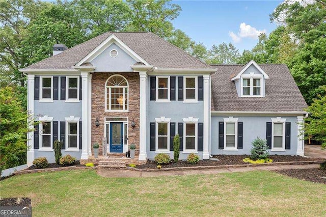 1039 Avery Creek Dr, Woodstock, GA 30188 - greek revival house with stucco siding, a front lawn, and stone siding