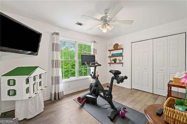 1039 Avery Creek Dr, Woodstock, GA 30188 - workout area with light wood-style flooring and ceiling fan