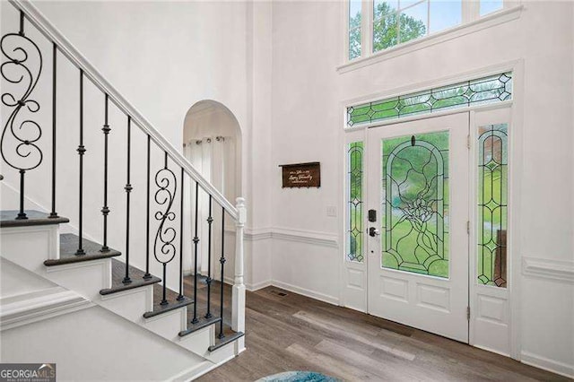 1039 Avery Creek Dr, Woodstock, GA 30188 - foyer with a high ceiling, stairs, and wood finished floors