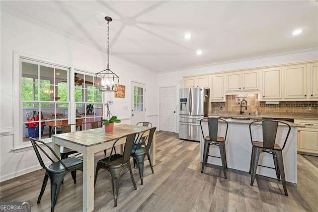 1039 Avery Creek Dr, Woodstock, GA 30188 - dining area featuring wood finished floors, ornamental molding, recessed lighting, and a chandelier