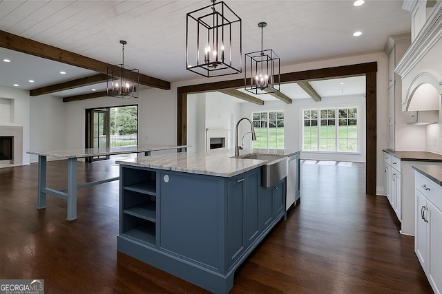 3084 Watsons Bnd, Milton, GA 30004 - kitchen with open floor plan, blue cabinets, a fireplace, dark wood-style flooring, and beam ceiling