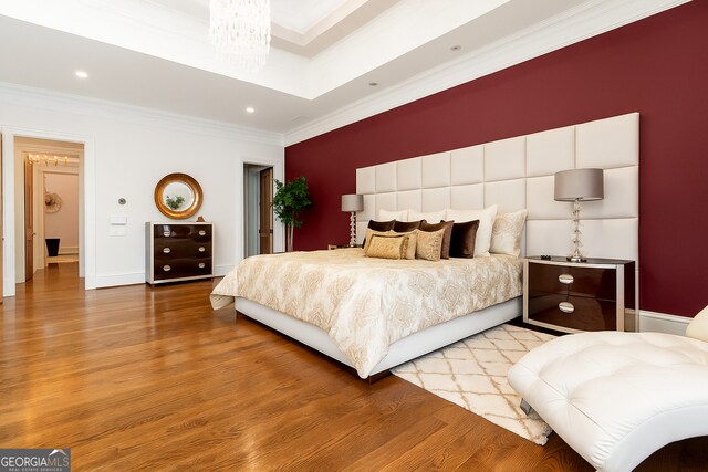 3084 Watsons Bnd, Milton, GA 30004 - unfurnished living room featuring crown molding, wood finished floors, a glass covered fireplace, and a raised ceiling