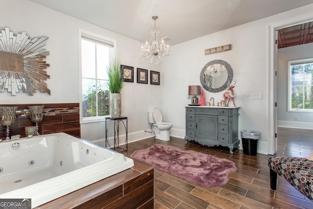 3084 Watsons Bnd, Milton, GA 30004 - bathroom featuring a chandelier, vanity, a tub with jets, and wood finish floors