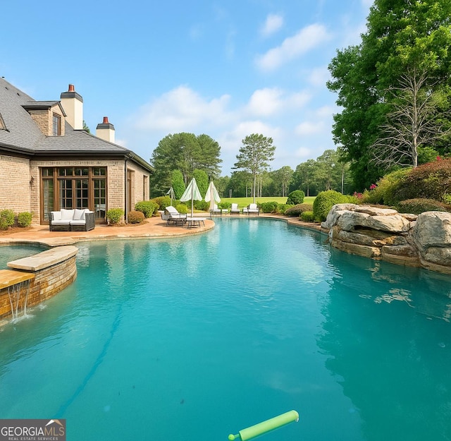 3084 Watsons Bnd, Milton, GA 30004 - view of swimming pool with a pool with connected hot tub, a patio area, and an outdoor hangout area