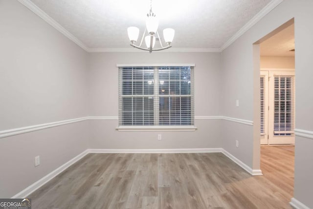 7113 Ambercrest Ct, Austell, GA 30168 - unfurnished dining area featuring wood finished floors, a chandelier, and crown molding