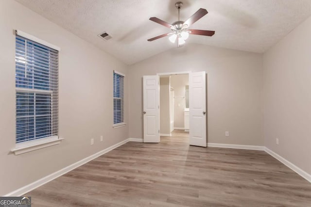 7113 Ambercrest Ct, Austell, GA 30168 - unfurnished bedroom featuring wood finished floors, vaulted ceiling, and a ceiling fan