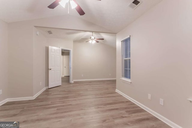 7113 Ambercrest Ct, Austell, GA 30168 - spare room featuring ceiling fan, vaulted ceiling, and light wood finished floors