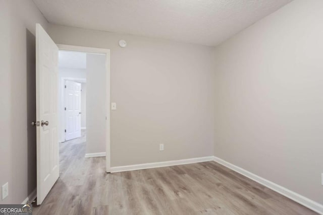 7113 Ambercrest Ct, Austell, GA 30168 - empty room with light wood-style flooring and a textured ceiling
