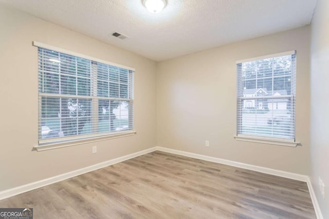7113 Ambercrest Ct, Austell, GA 30168 - empty room featuring wood finished floors and a textured ceiling