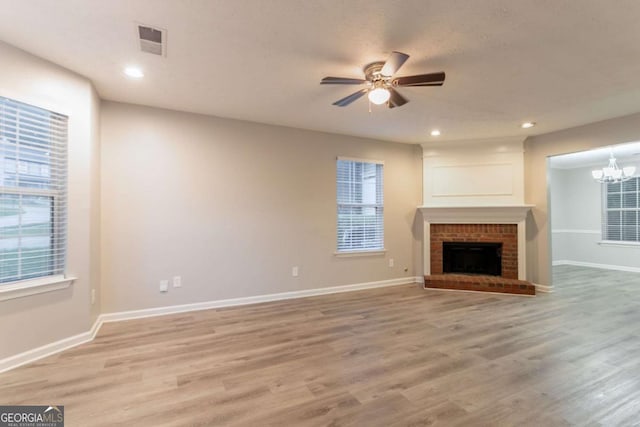 7113 Ambercrest Ct, Austell, GA 30168 - unfurnished living room featuring a ceiling fan, light wood finished floors, plenty of natural light, a chandelier, and recessed lighting