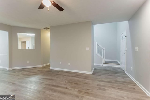 7113 Ambercrest Ct, Austell, GA 30168 - spare room featuring stairs, wood finished floors, and ceiling fan