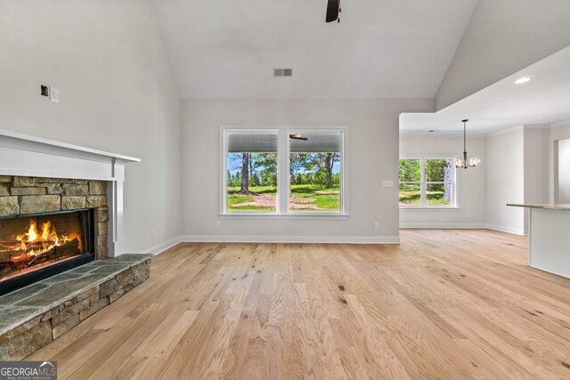 21 Oakgrove Trl, Griffin, GA 30224 - unfurnished living room with a fireplace, a chandelier, light wood-style floors, high vaulted ceiling, and a ceiling fan