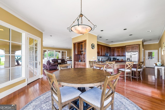 745 Chickasaw Trl S, Sparta, GA 31087 - dining area featuring light wood-style floors, recessed lighting, ornamental molding, and baseboards