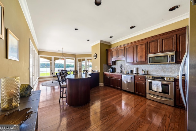745 Chickasaw Trl S, Sparta, GA 31087 - kitchen with appliances with stainless steel finishes, dark wood-type flooring, decorative backsplash, a kitchen bar, and ornamental molding