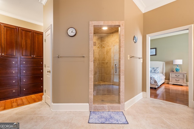 745 Chickasaw Trl S, Sparta, GA 31087 - ensuite bathroom featuring ornamental molding, a shower stall, baseboards, and tile patterned flooring