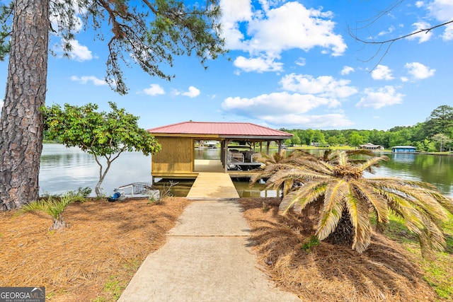 745 Chickasaw Trl S, Sparta, GA 31087 - view of front facade featuring boat lift, a dock, a water view, and metal roof