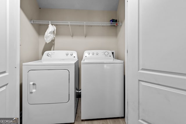 2140 Wildcat Cliffs Way, Lawrenceville, GA 30043 - washroom with washer and dryer and wood finished floors