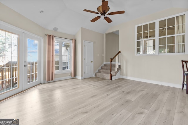 2140 Wildcat Cliffs Way, Lawrenceville, GA 30043 - unfurnished living room featuring stairway, lofted ceiling, a ceiling fan, and wood finished floors