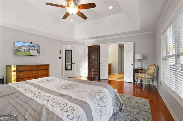 3224 Wolf Club Ln SW, Atlanta, GA 30349 - bedroom with a raised ceiling, wood finished floors, baseboards, ornamental molding, and a ceiling fan