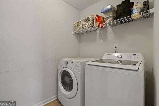 3224 Wolf Club Ln SW, Atlanta, GA 30349 - washroom featuring washing machine and dryer and baseboards