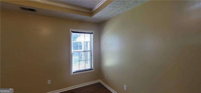 1934 Mcconnell Rd, Grayson, GA 30017 - unfurnished room with ornamental molding, dark wood finished floors, and a tray ceiling