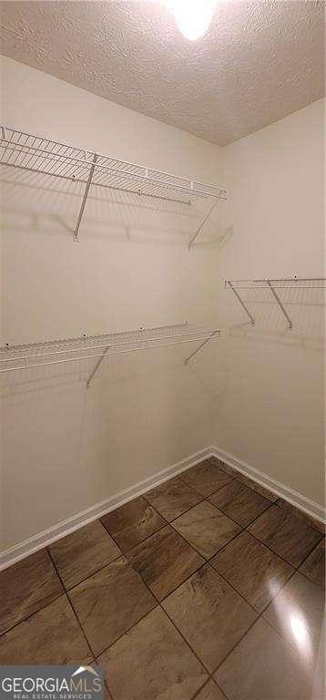 1934 Mcconnell Rd, Grayson, GA 30017 - spacious closet featuring dark tile patterned floors