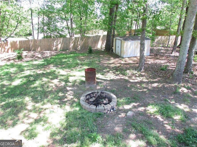 1934 Mcconnell Rd, Grayson, GA 30017 - fenced backyard featuring a storage unit and an outdoor fire pit