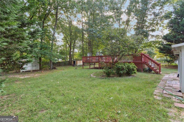 1934 Mcconnell Rd, Grayson, GA 30017 - view of green lawn featuring a wooden deck, a storage unit, and stairs