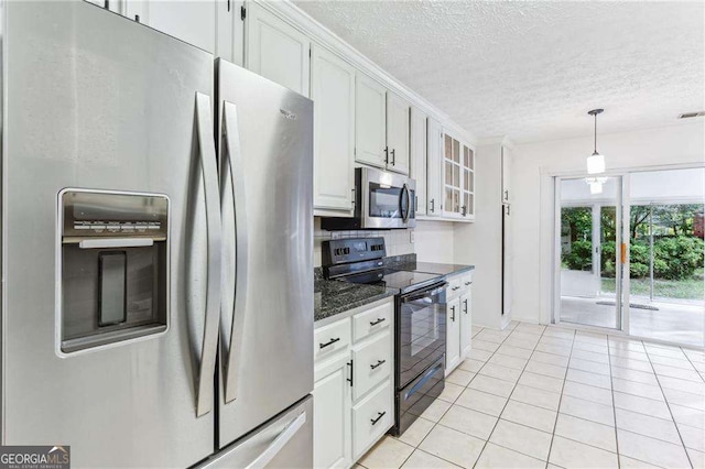1934 Mcconnell Rd, Grayson, GA 30017 - kitchen with stainless steel appliances, glass insert cabinets, a textured ceiling, light tile patterned floors, and white cabinets