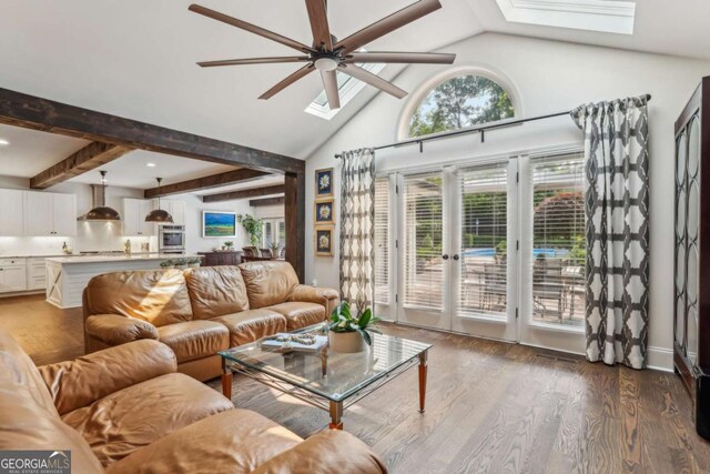 5860 Riverwood Dr, Sandy Springs, GA 30328 - living room with a skylight, ceiling fan, wood finished floors, high vaulted ceiling, and beamed ceiling