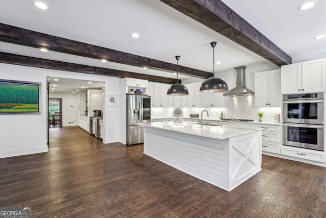 5860 Riverwood Dr, Sandy Springs, GA 30328 - kitchen featuring appliances with stainless steel finishes, wall chimney exhaust hood, a sink, beam ceiling, and dark wood-style flooring