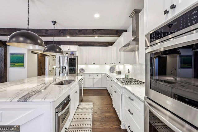 5860 Riverwood Dr, Sandy Springs, GA 30328 - kitchen with appliances with stainless steel finishes, an island with sink, dark wood-type flooring, beamed ceiling, and a sink