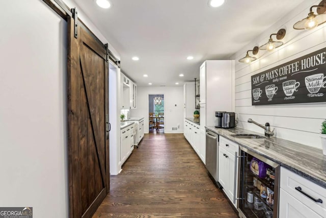 5860 Riverwood Dr, Sandy Springs, GA 30328 - kitchen featuring a barn door, beverage cooler, a sink, dishwasher, and white cabinetry