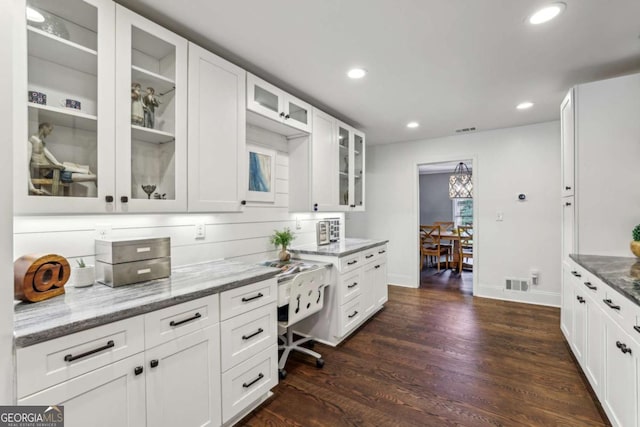 5860 Riverwood Dr, Sandy Springs, GA 30328 - kitchen featuring light stone countertops, dark wood-type flooring, recessed lighting, white cabinets, and glass insert cabinets