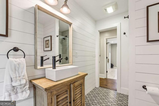 5860 Riverwood Dr, Sandy Springs, GA 30328 - bathroom featuring vanity, tiled shower, and wooden walls