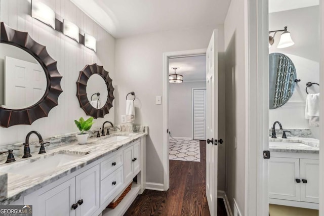 5860 Riverwood Dr, Sandy Springs, GA 30328 - bathroom featuring double vanity, wood finished floors, and baseboards