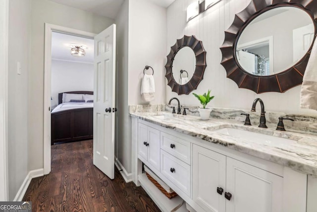 5860 Riverwood Dr, Sandy Springs, GA 30328 - ensuite bathroom featuring wood finished floors, double vanity, and baseboards