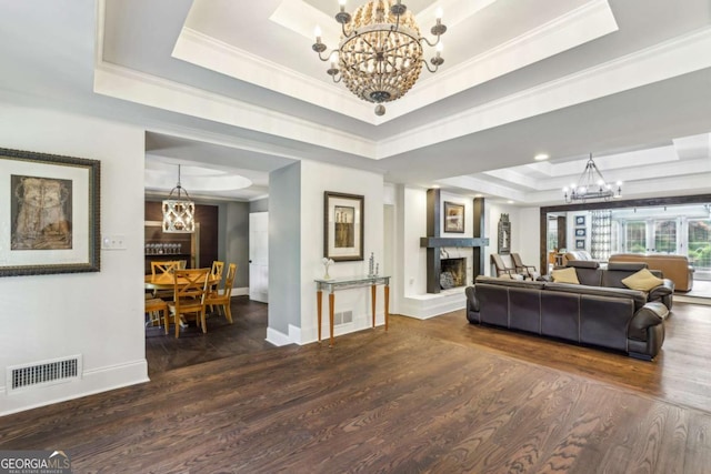 5860 Riverwood Dr, Sandy Springs, GA 30328 - living room featuring a tray ceiling, a chandelier, a fireplace with raised hearth, wood finished floors, and baseboards